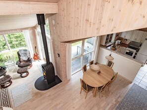 A modern interior with a fireplace, dining area, and kitchen. - 6 Person Holiday Home in Albaek (Aalbaek)