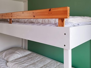 A bunk bed with a wooden headboard and white bedding. - 6 Person Holiday Home in Hojby (Hojby)