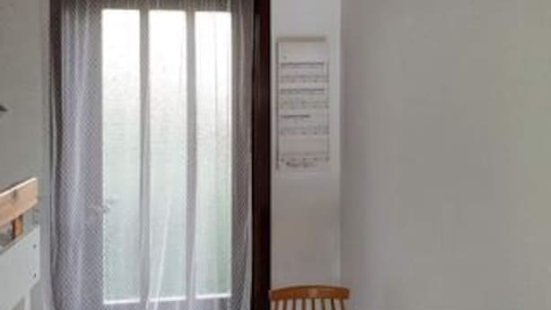 A room with a window, a chair, and a wall-mounted sign. - 6 Person Holiday Home in Hojby (Hojby)