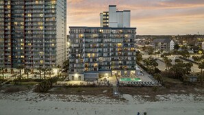 A high-rise hotel with multiple balconies and a pool area. - Romantic Oceanfront Condo w/ Beach Access, King Bed, Onsite Bar & Restaurant! (Myrtle Beach)