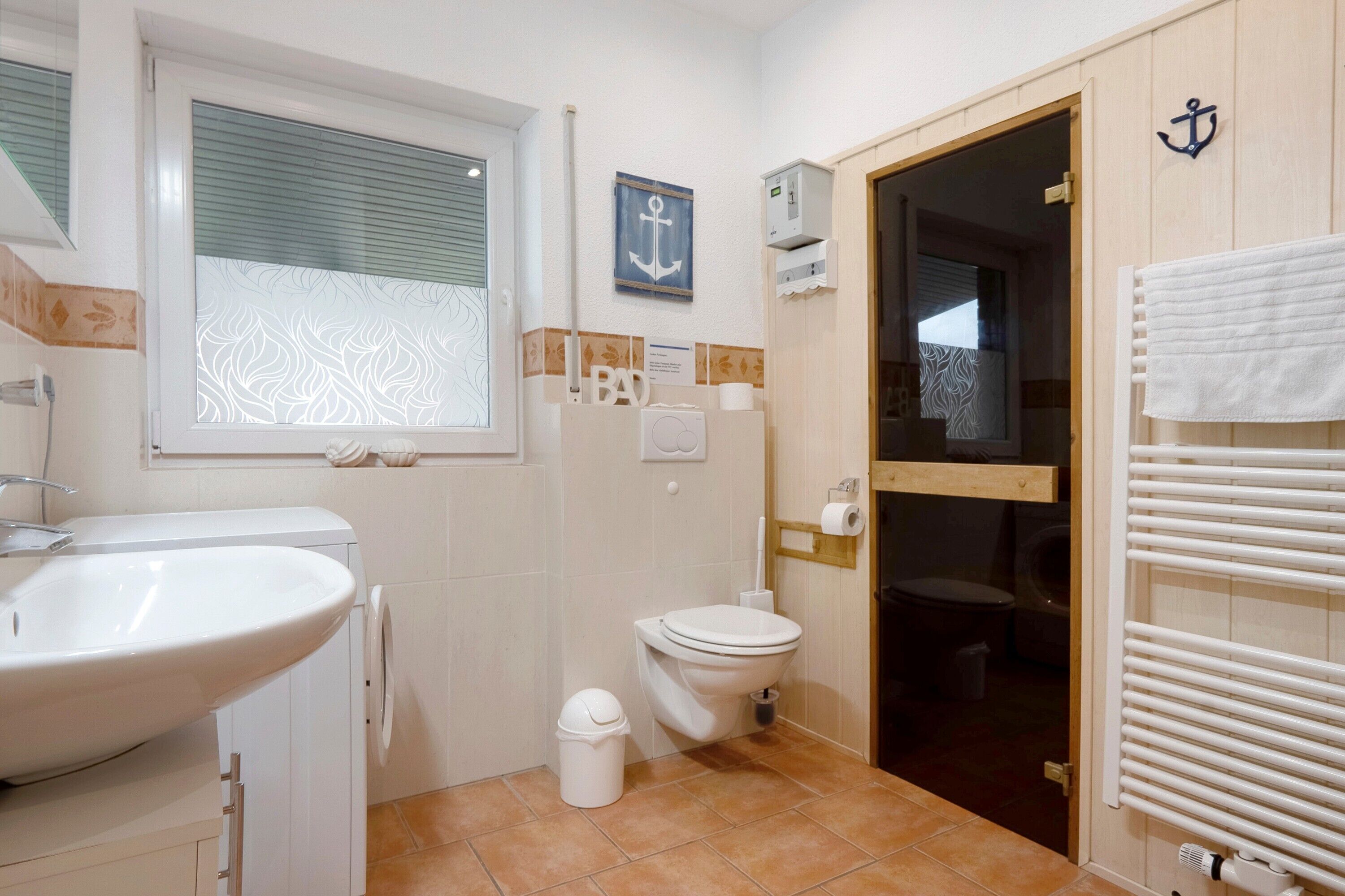 Un baño con lavamanos, inodoro y zona de ducha.
