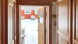 A wooden hallway with a door leading to a snowy outdoor area. - 4 Person Holiday Home in Tallberg-by Traum (Tallberg)