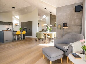 A modern living space with a kitchen, dining area, and seating area. - 8 Person Holiday Home in Hirtshals (Hirtshals)