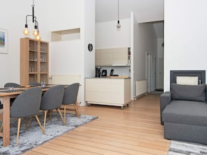 A modern living space with a dining area, kitchen, and seating area. - 6 Person Holiday Home in Ebeltoft (Ebeltoft)