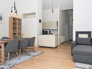 A modern living space with a dining area, kitchen, and seating area. - 6 Person Holiday Home in Ebeltoft (Ebeltoft)