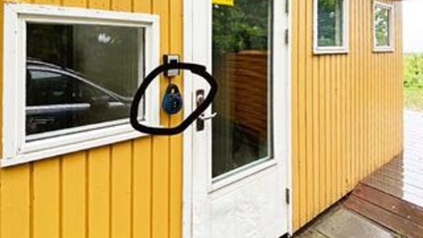 A yellow building with a window, a door, and a small window above the door. - 6 Person Holiday Home in Aakirkeby (Akirkeby)