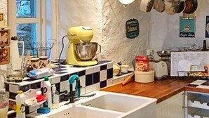 A kitchen with a checkered backsplash, a yellow stand mixer, and a white sink. - 4 Star Holiday Home in Bruvik (Masfjorden)