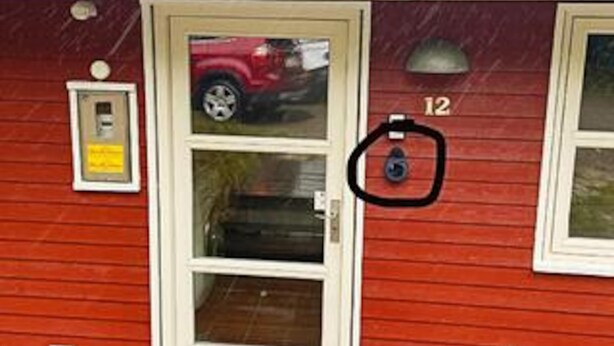 A red building with a door, a mailbox, and a number '12' on the wall. - 4 Star Holiday Home in Aakirkeby (Akirkeby)