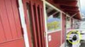 A red building with a wooden deck and a door. - 5 Person Holiday Home in Aabenraa (Aabenraa)