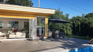 A modern outdoor pool area with a covered seating area, a pool, and a patio with outdoor furniture. - 10 Person Holiday Home in Arendal-by Traum (Arendal)
