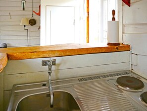 A kitchen with a sink, a wooden countertop, and a window with a view. - 5 Person Holiday Home in Flen (Flen)