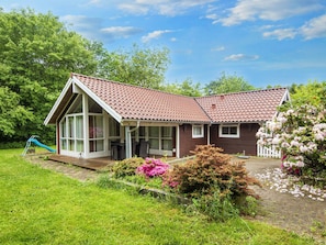 A two-story house with a red-tiled roof, large windows, and a wooden deck. - 7 Person Holiday Home in Toftlund-by Traum (Toftlund)