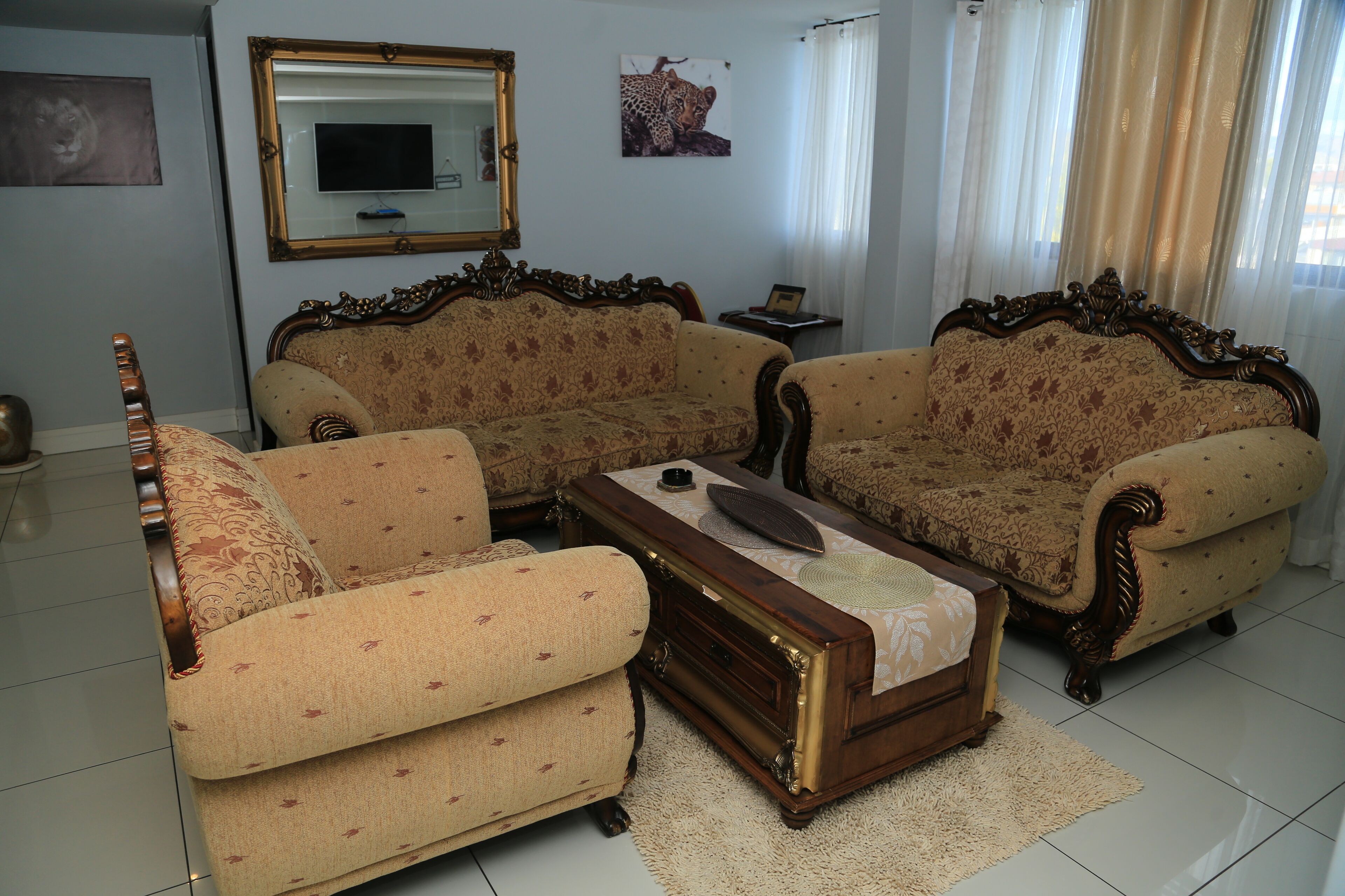A living room with two sofas, a coffee table, a TV, and a framed picture on the wall.