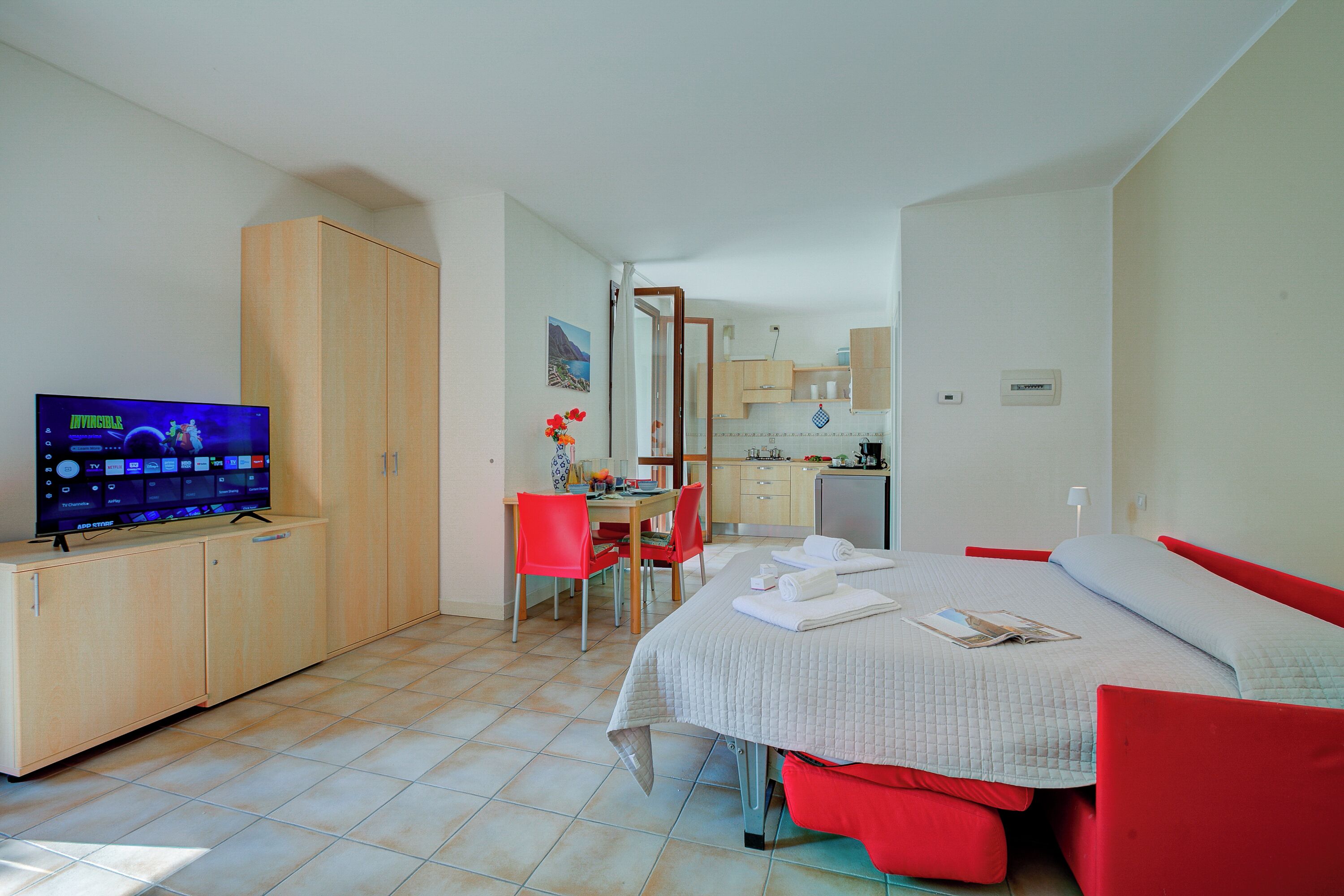 Une chambre à coucher avec un lit, une télévision, un bureau et une chaise.