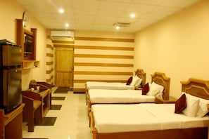 Traditional Triple Room | Living room | 32-inch LED TV with cable channels, TV, fireplace - HOTEL CROWN (Hyderabad)