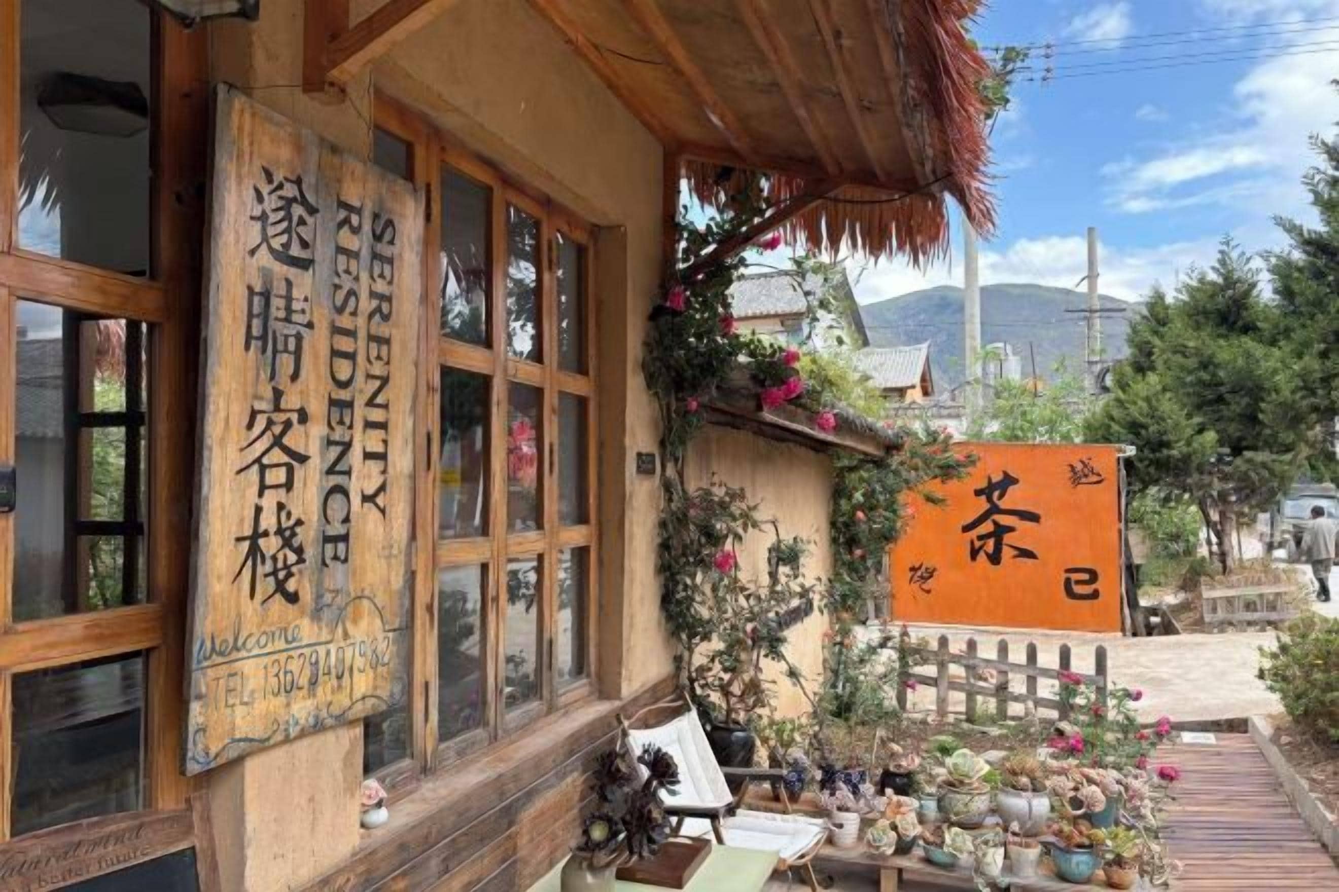A traditional Japanese building with wooden windows and a thatched roof.