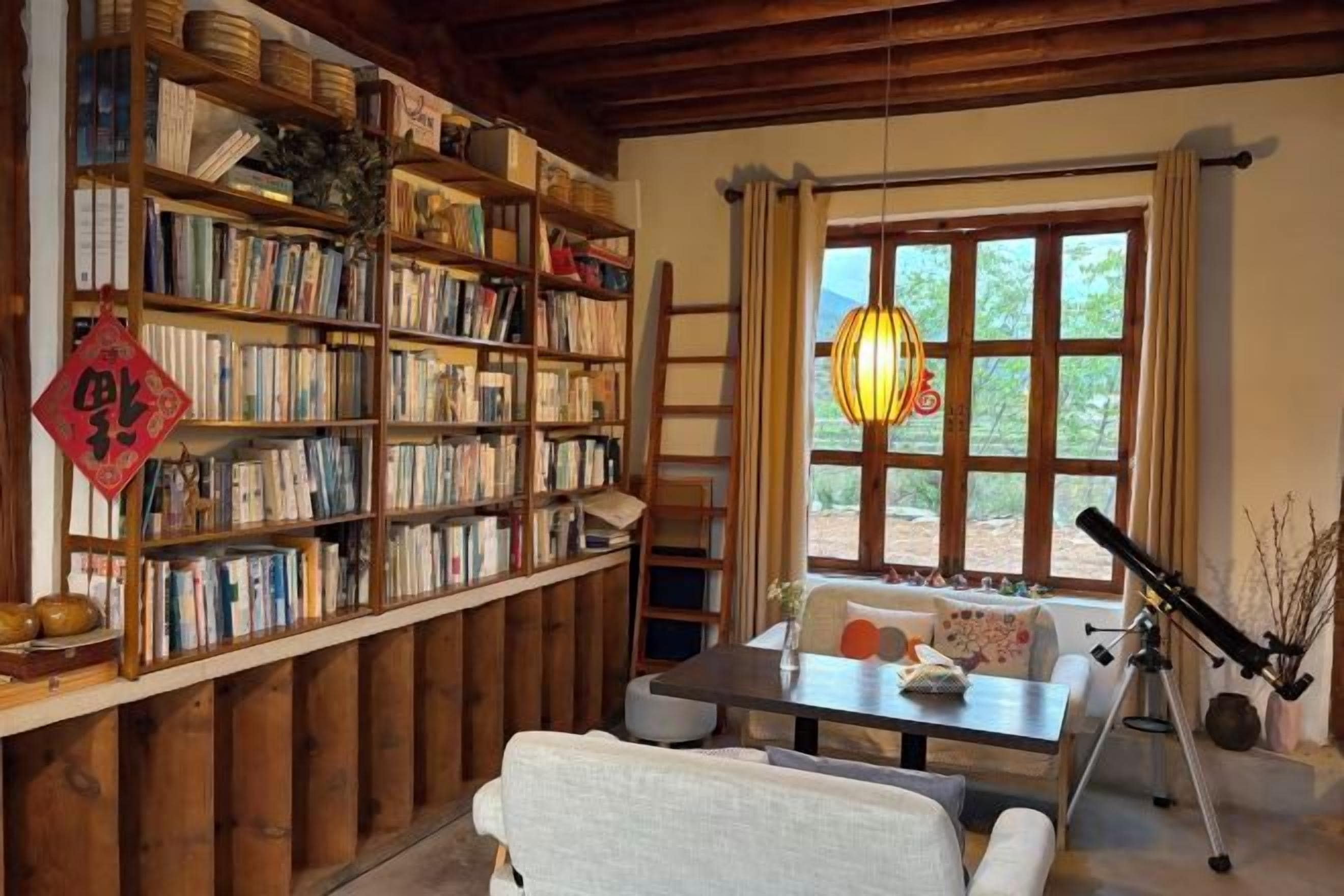 A cozy room with a bookshelf, a telescope, and a window with a view.