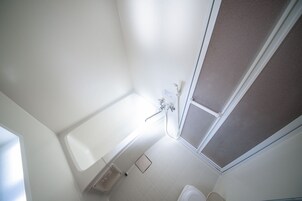A bathroom with a bathtub, a shower, and a toilet.