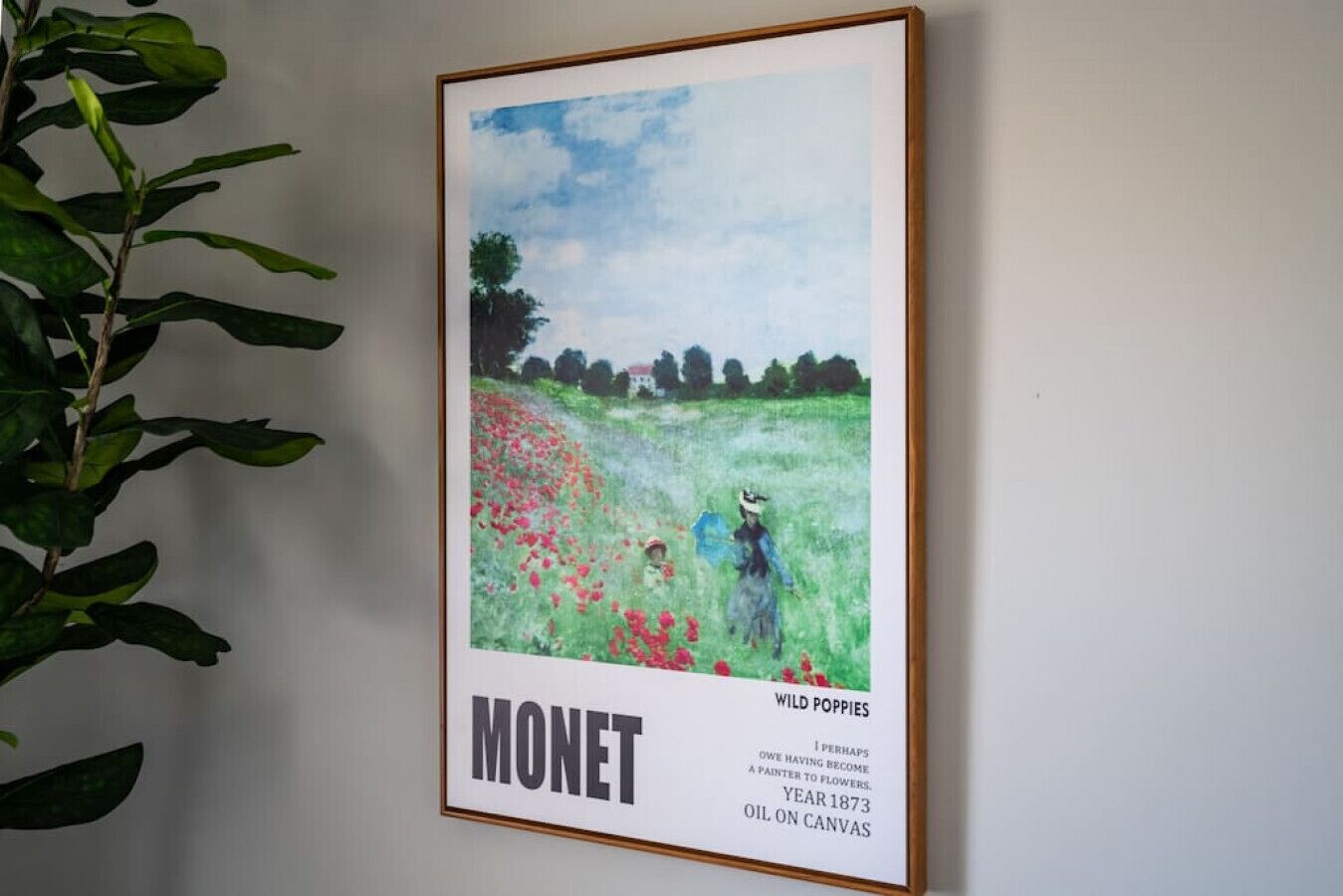 A framed painting of wild poppies by Monet, titled 'I Perhaps Owe Having Become a Painter to Flowers,' from 1873, on a wall.