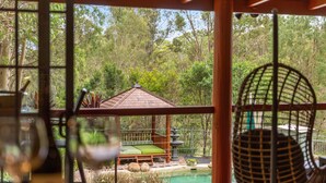 A view of a wooden deck with a green mat, a small gazebo, and a fountain. - Stylish rural retreat on the foothills of Mt. Mee (Moorina)