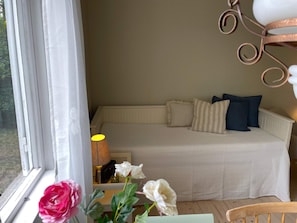 A bedroom with a bed, pillows, a lamp, and a window with curtains. - 4 Person Holiday Home in 38472 (Timmernabben)