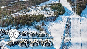 A snow-covered mountain area with a ski resort, including multiple chalet-style buildings and a ski lift. - 4 Star Holiday Home in Noresund (Krodsherad)
