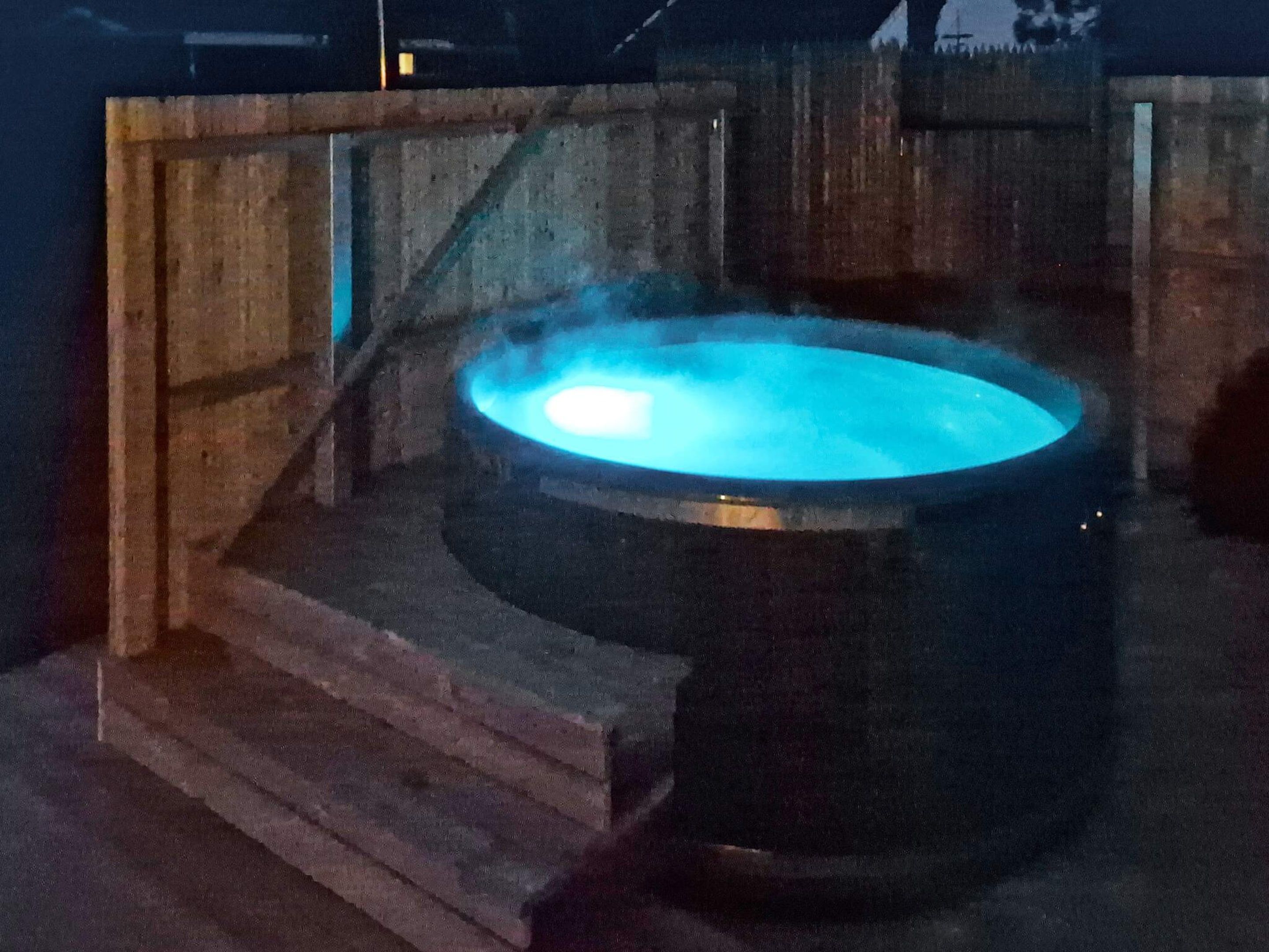 A hot tub with a wooden structure around it.