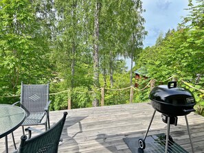 A deck with outdoor furniture and a grill. - 4 Person Holiday Home in Varmdo (Värmdö)
