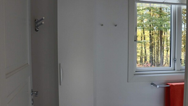 A room with a window, a door, and a towel rack. - 4 Person Holiday Home in Skanes-fagerhult (Skånes Fagerhult)