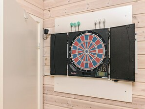 A dartboard mounted on a wall with a wooden panel background. - 9 Person Holiday Home in Vaeggerlose (Vaeggerlose)