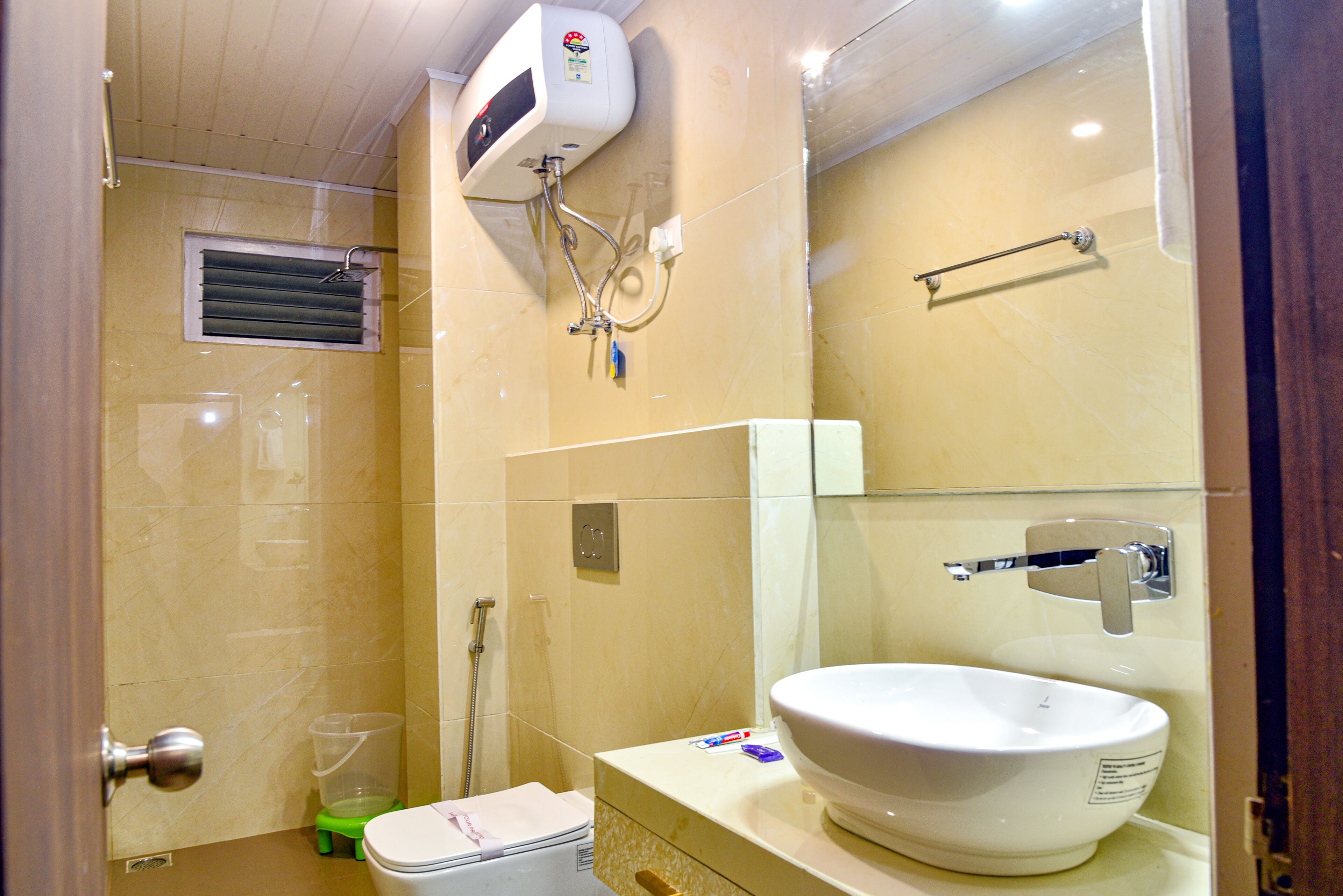 A bathroom with a toilet, sink, and shower.