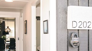 A hallway leading to a room with a door labeled 'D202' and a padlock on the door. - 6 Person Holiday Home in Ringkobing (Ringkobing)