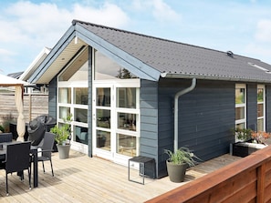 A modern house with a deck, large windows, and a covered patio area. - 4 Star Holiday Home in Otterup (Otterup)