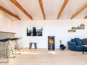 A modern living room with a fireplace, a television, and a sofa.