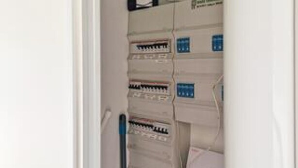 A wall-mounted electrical panel with multiple circuit breakers. - 5 Star Holiday Home in Lokken (Lokken)