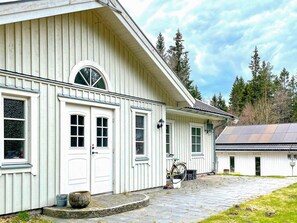 A white building with a large arched window, a door, and a small porch area. - 4 Star Holiday Home in Ulricehamn (Ulricehamn)