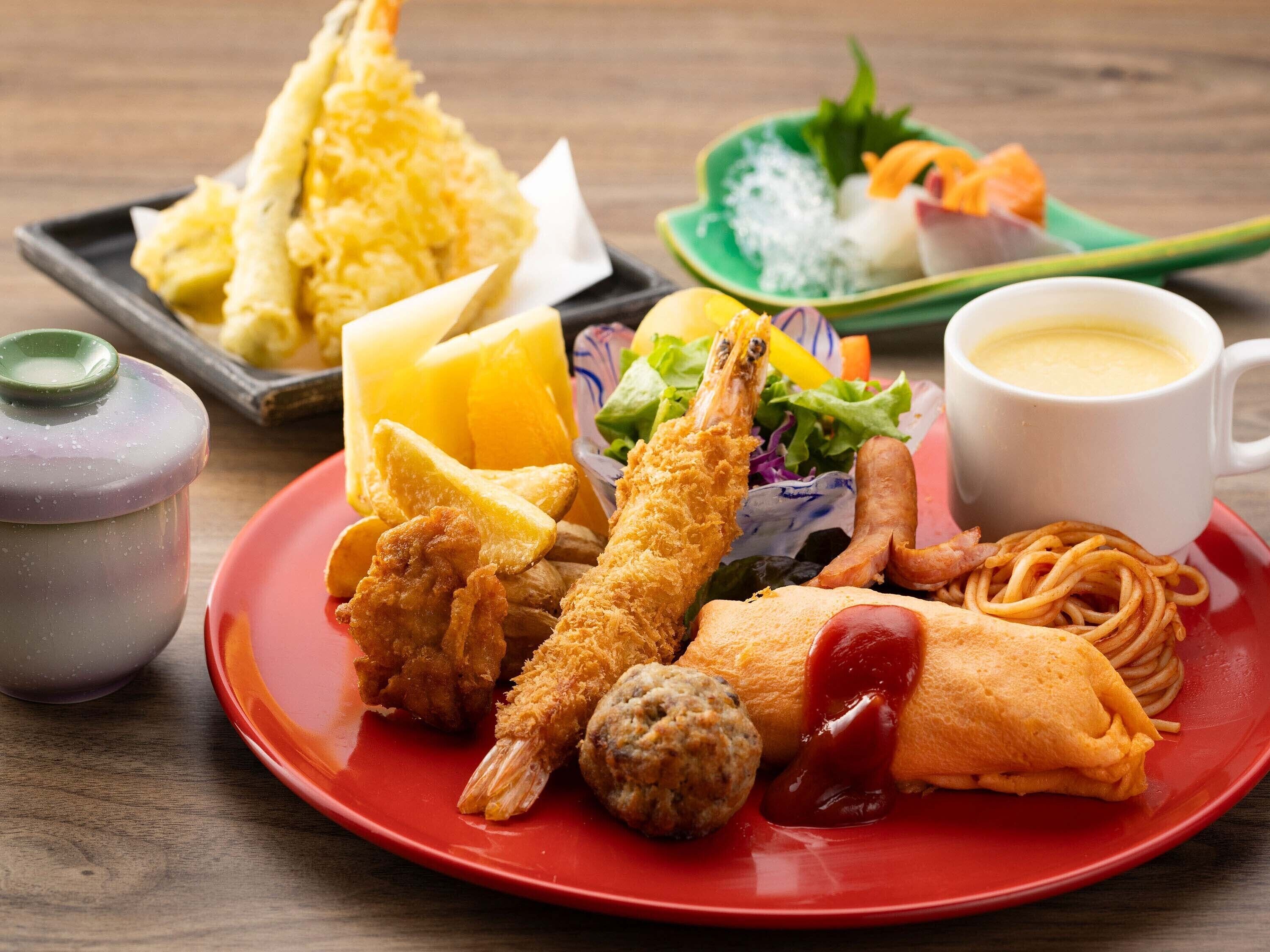 A variety of Japanese dishes including tempura, noodles, and a salad on a red plate.