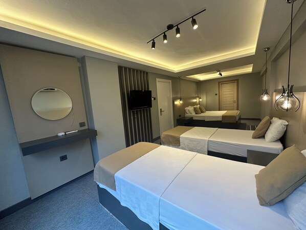 A modern hotel room with two beds, a flat-screen TV, a mirror, and ambient lighting. - Panula Park Hotel (Izmir)
