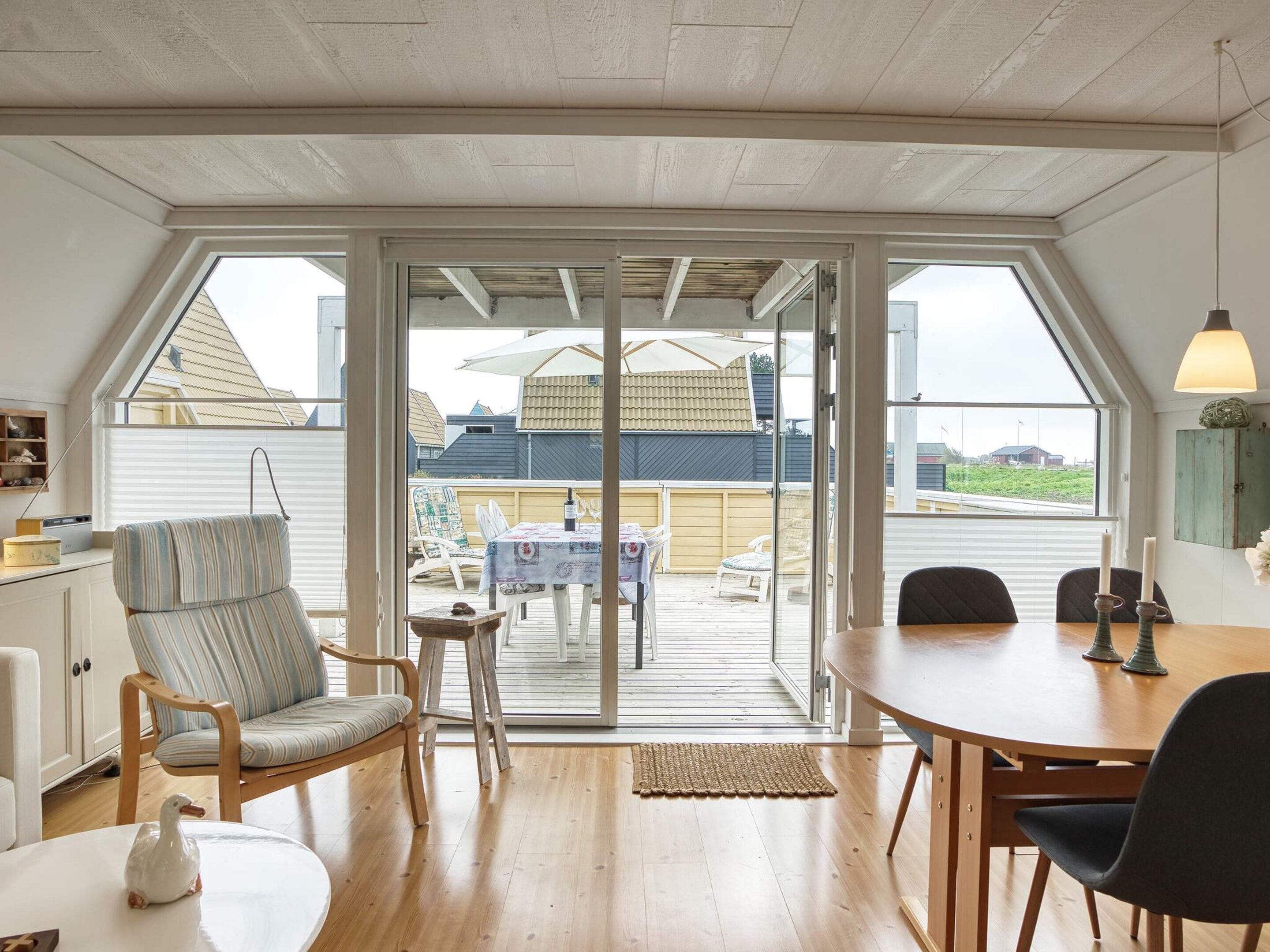 A room with a large sliding glass door leading to an outdoor patio area.