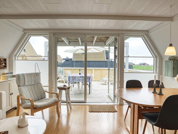 A room with a large sliding glass door leading to an outdoor patio area. - 4 Person Holiday Home in Gedser (Gedser)
