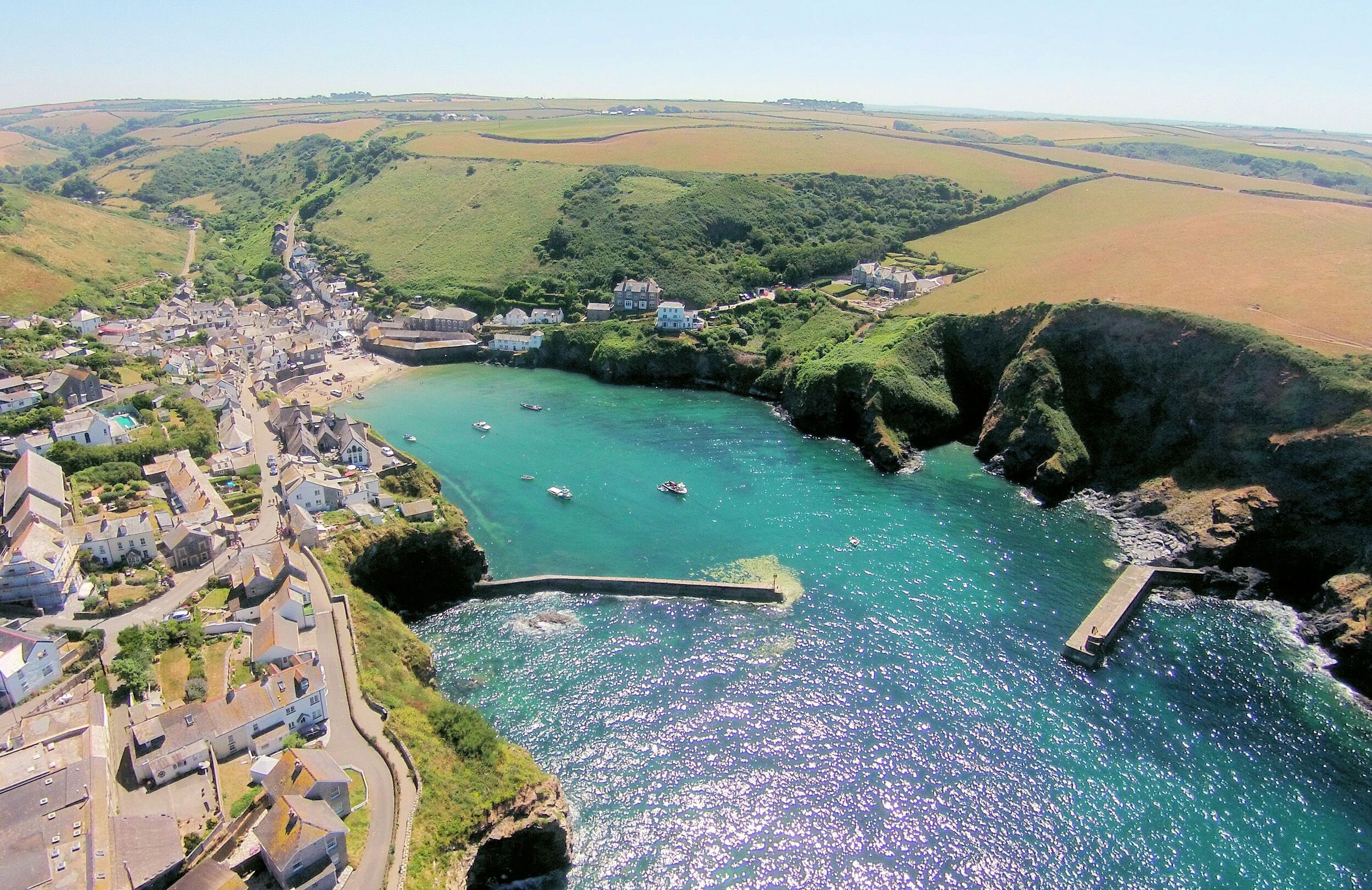 A coastal town with a harbor, boats, and a pier.