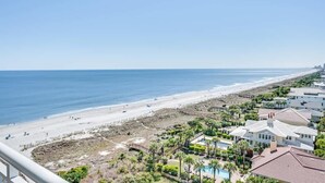 A coastal view with a beach, a pool, and residential buildings. - Newly Remodeled,Dunes Village 2BR,Indoor Waterpark (Myrtle Beach)