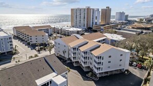 A coastal hotel complex with multiple buildings, including a prominent high-rise.