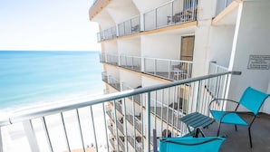 A balcony with a view of the sea, equipped with metal railings and two turquoise chairs. - NEW Ocean Annie's Oceanview Studio - Heated Pools! (Myrtle Beach)