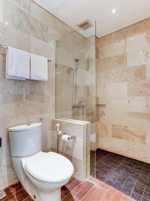 A modern bathroom with a glass-enclosed shower, a toilet, and a towel rack. - Collection O Legian Near Pantai Kuta Formerly Premium Legian (Legian)