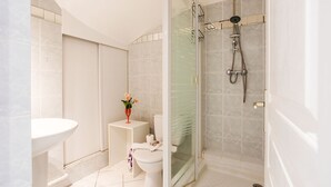 A modern bathroom with a glass-enclosed shower, a white sink, and a toilet. - LE FLORIDA AP4340 By Riviera Holiday Homes (Villefranche-sur-Mer)