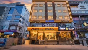 A hotel with a modern facade, multiple floors, and a prominent entrance with a staircase. - Fabhotel Rove Inn & Suites (Bengaluru)