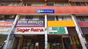 A hotel named 'Hotel Absolute Comfort' with a sign for 'Sagar Ratna' and a South Indian, North Indian, Chinese Veg Restaurant. - Fabhotel Comfort 35 (Chandigarh)