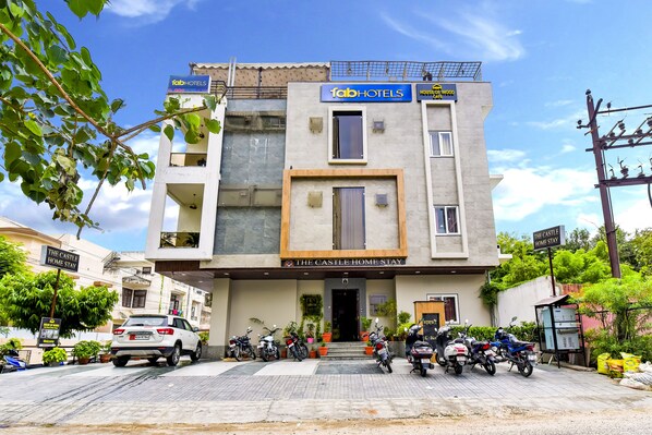 A building with a sign reading "TabHotels" and "The Castle Home Stay".