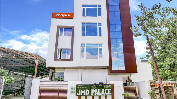 A modern building with a sign indicating it is a hotel and restaurant. - FabHotel The Gayatri Palace (Lucknow)